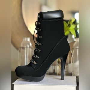 JUSTFAB. BRAND NEW- Never worn with tags. Heel boots in black.